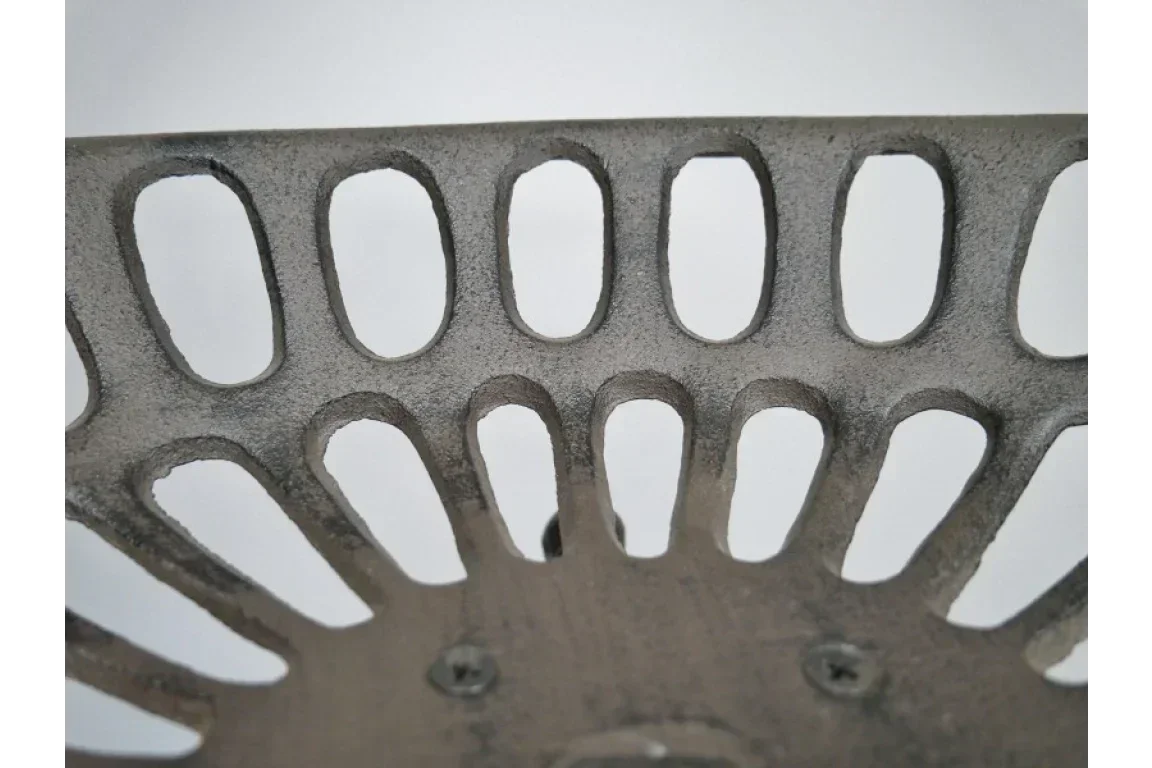 Close-up of metal dining chair backrest with oval cut-out design