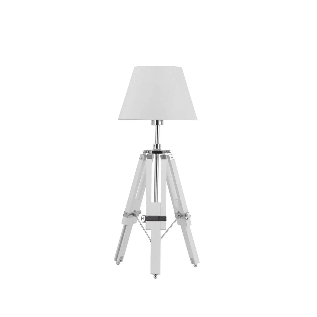 White tripod table lamp with chrome accents and cone-shaped shade on white background