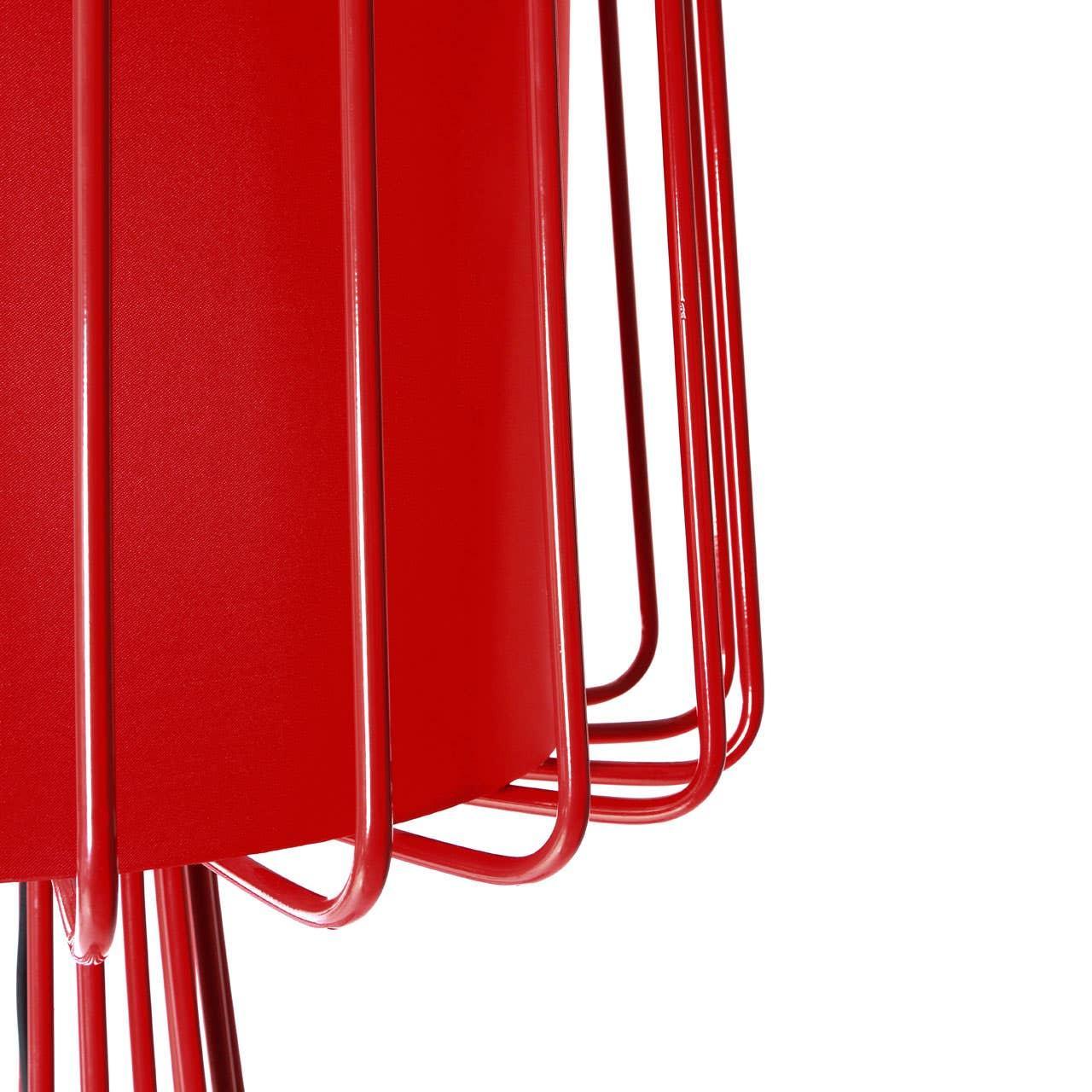 Close-up of red metal lamp shade with geometric wire frame detail