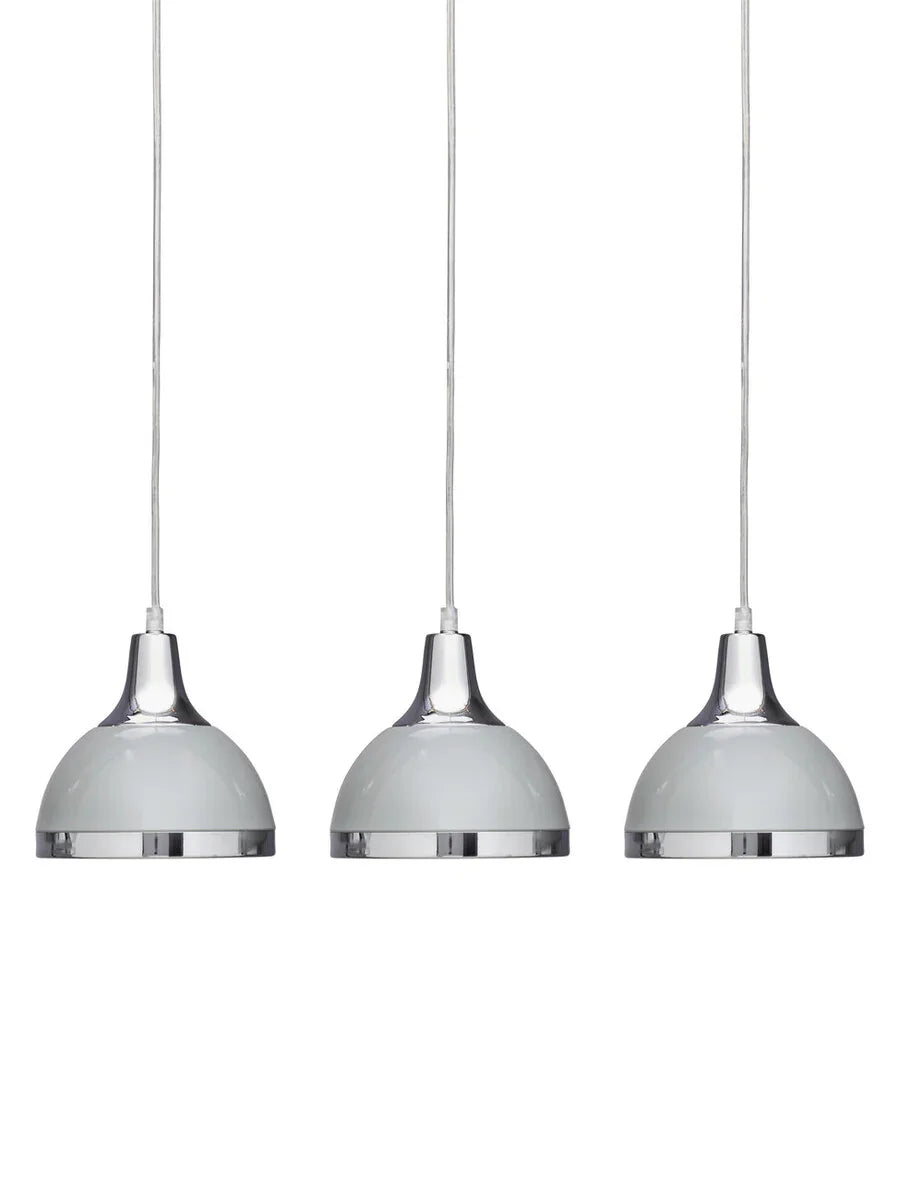 Set of three chrome pendant lights with white domed shades, suspended on cables