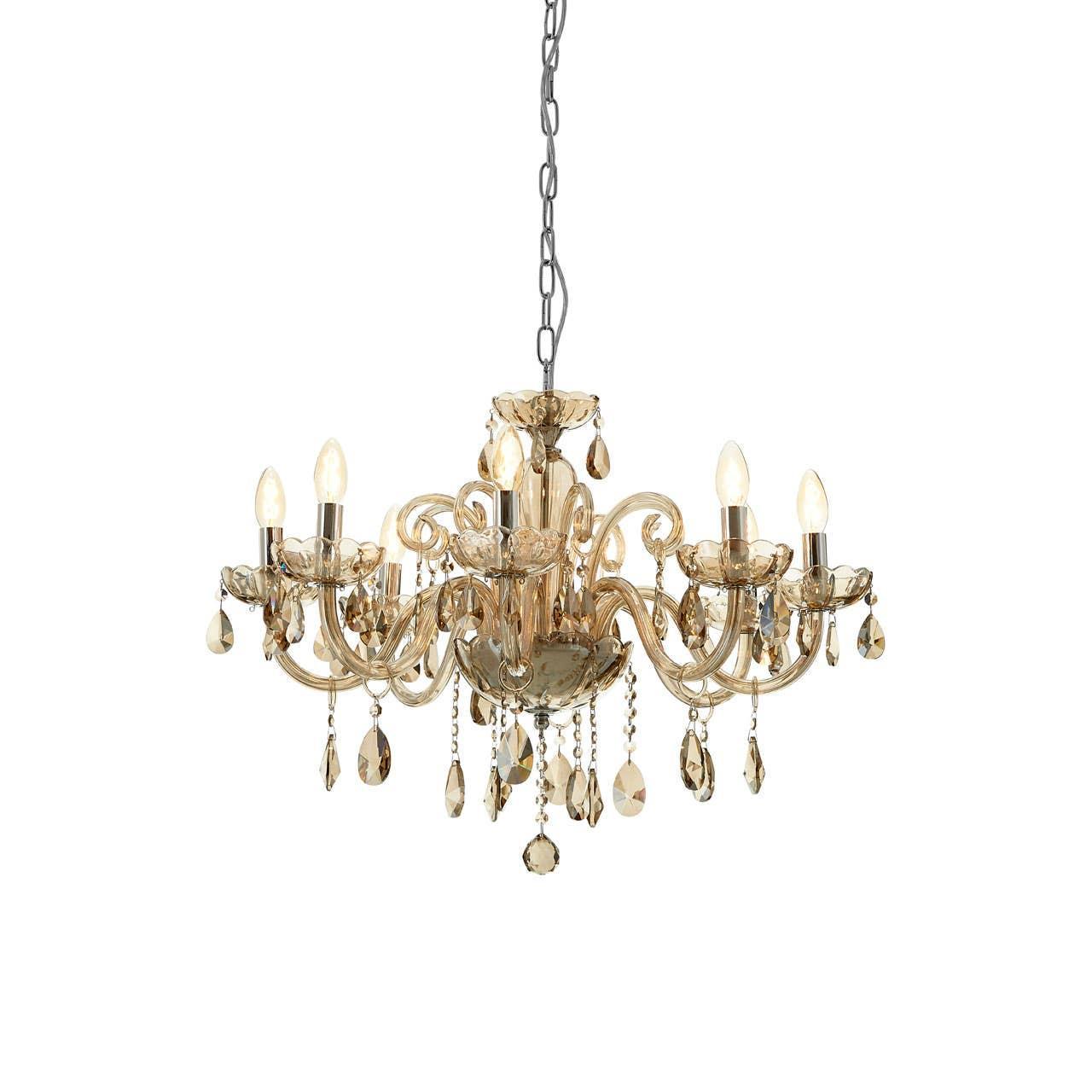 Gold crystal chandelier with candle-style bulbs and hanging glass droplets