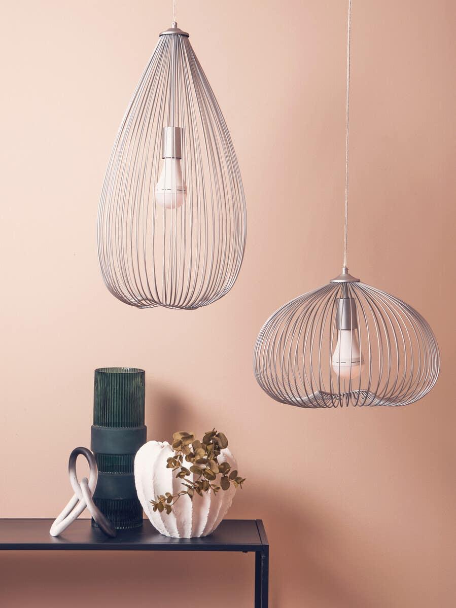 Modern pendant lighting with metal wire shades above console table and decorative vases