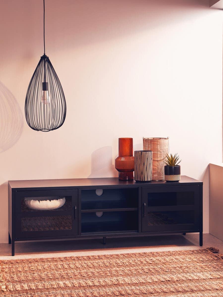Black TV unit with glass doors, decorative vases, and pendant light on woven rug