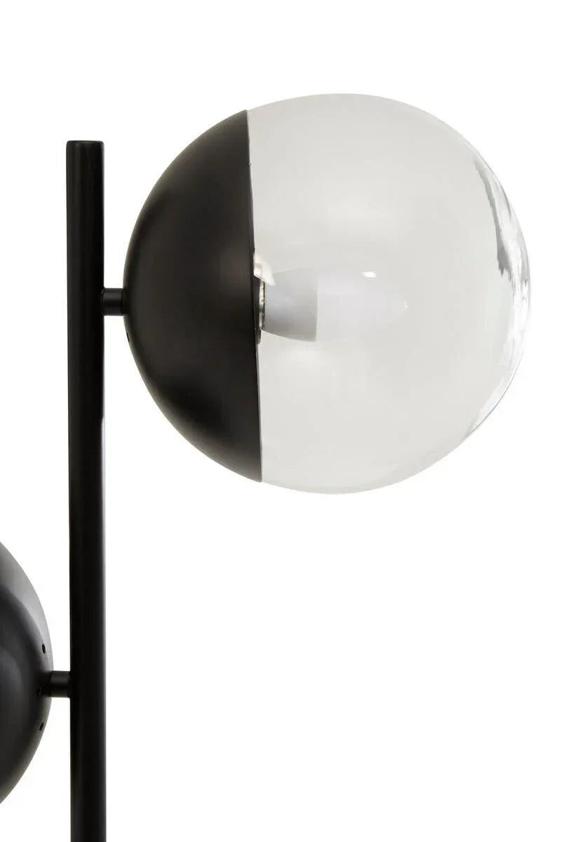 modern glass globe floor lamp with black metal base and clear shade detail