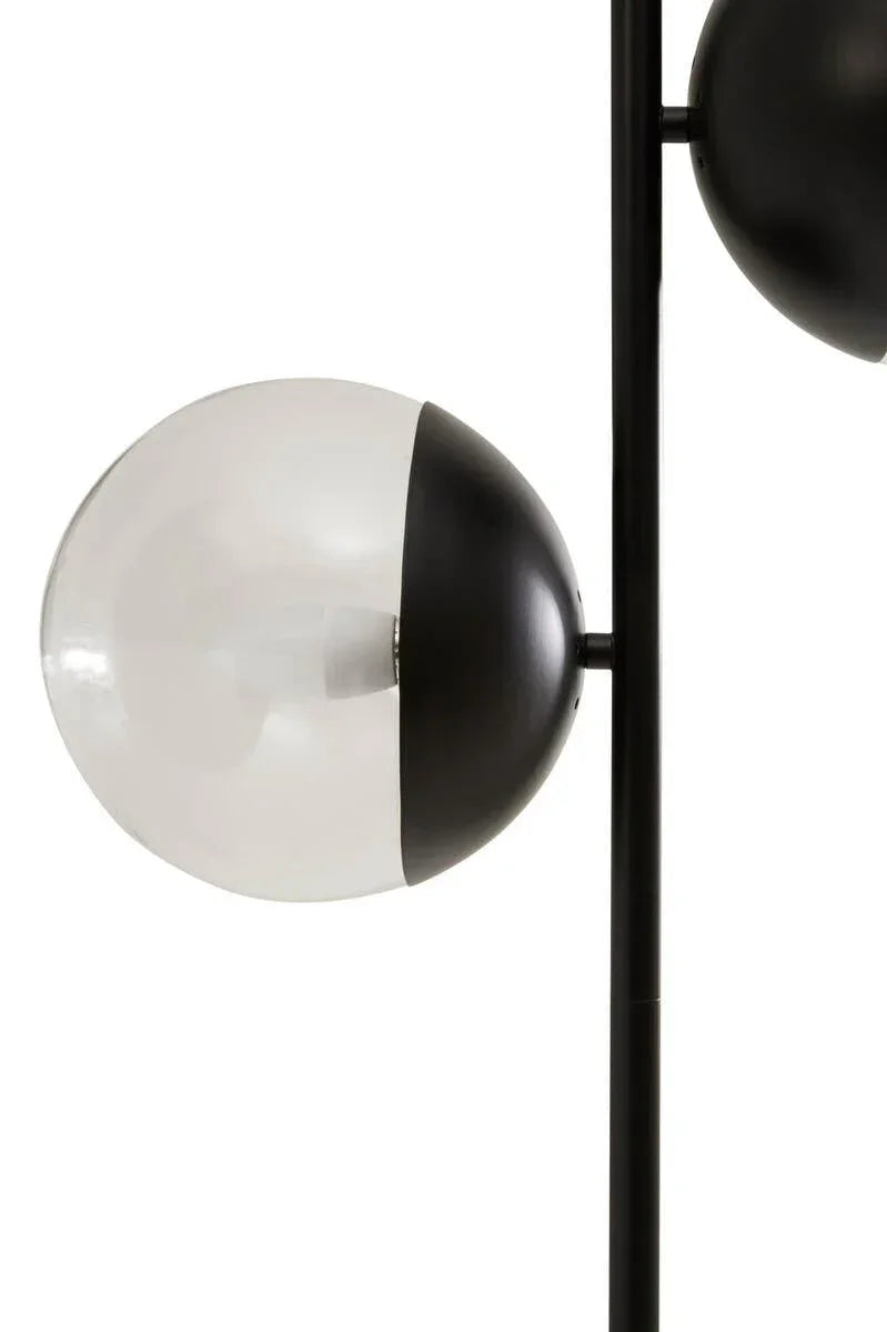 Modern floor lamp with spherical black and white glass shade and metal stem