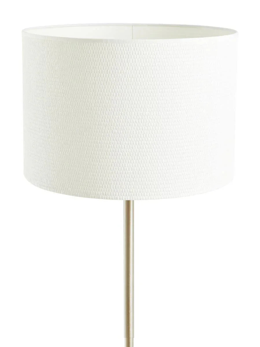 White fabric drum lampshade on slim metal floor lamp