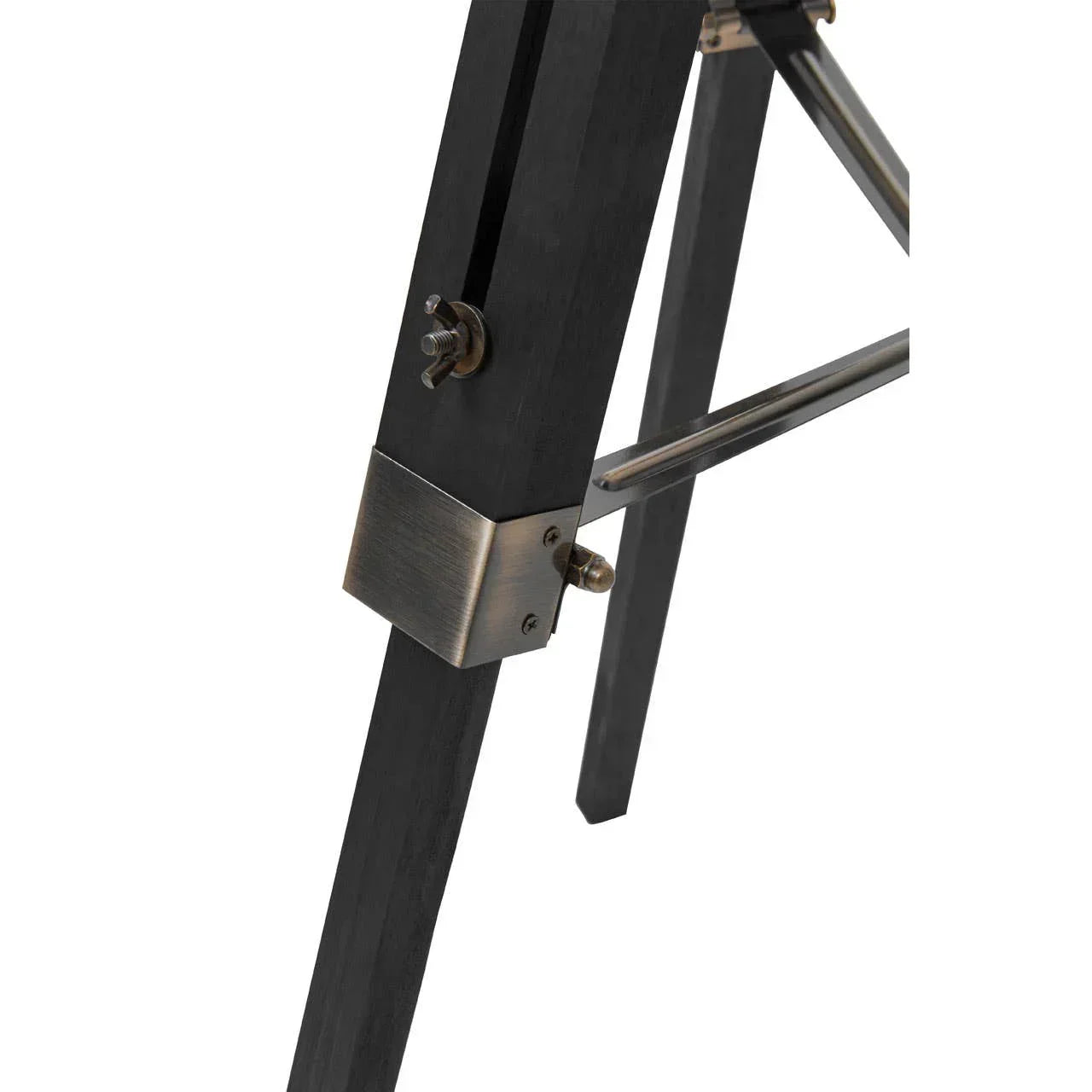 Close-up of black wooden furniture leg with brass hardware and metal support bar