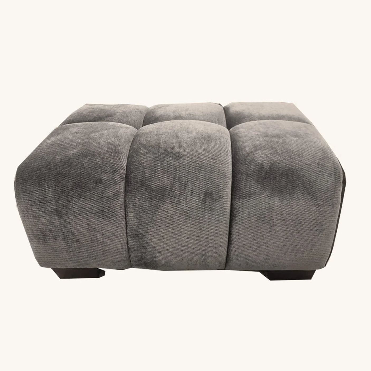 Grey velvet ottoman with tufted cushion and block feet, front view