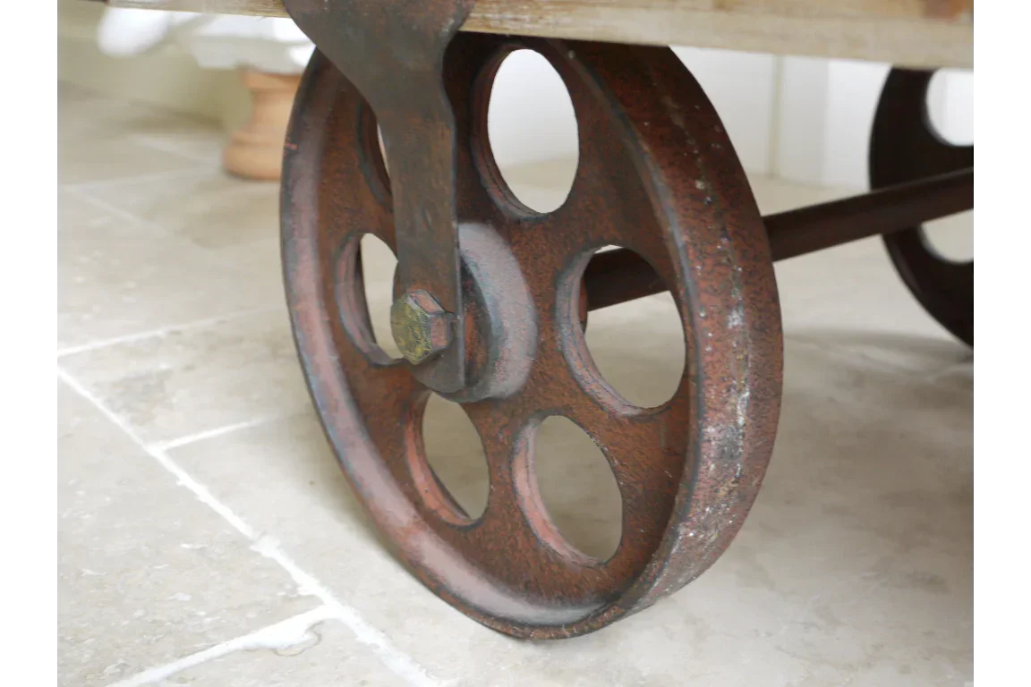 Close-up of industrial metal furniture caster wheel on stone tile floor