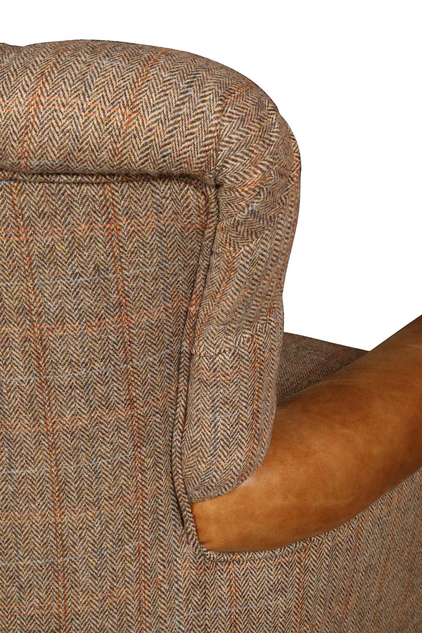 Closeup of tweed armchair with brown leather accent on armrest