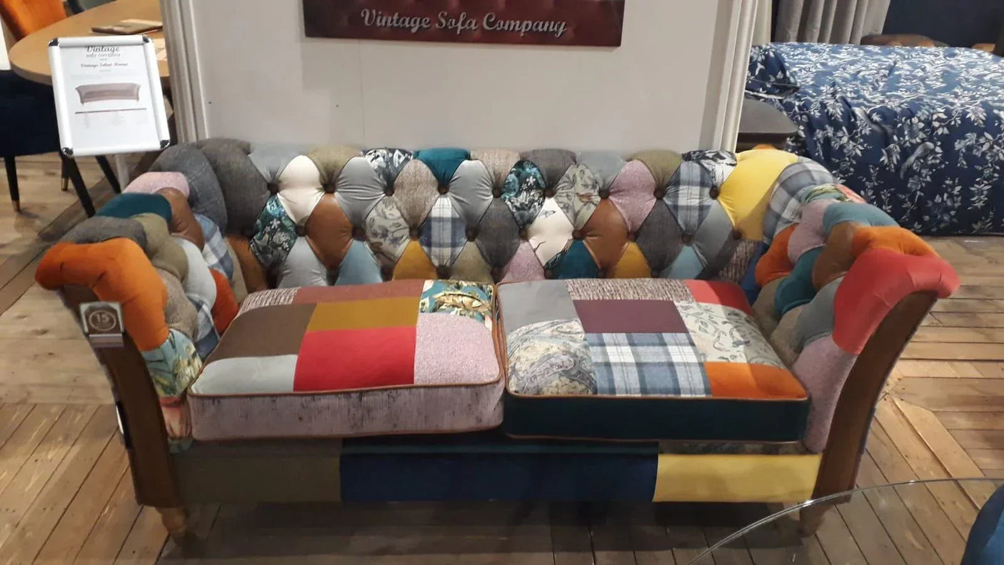 Patchwork velvet sofa with button tufting and wooden legs on wooden floor