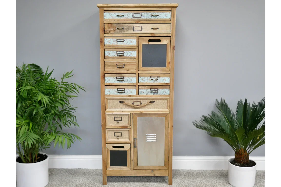 Tall rustic wooden chest of drawers with mixed drawer fronts against grey wall