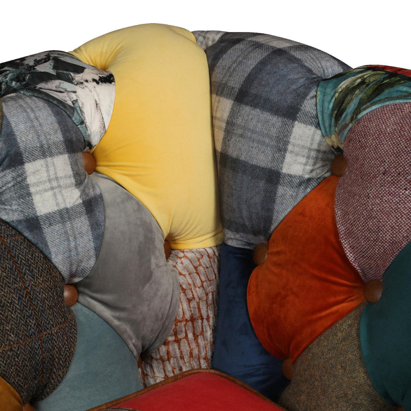 Patchwork fabric sofa backrest with plaid, velvet, and textured cushions in mixed colors