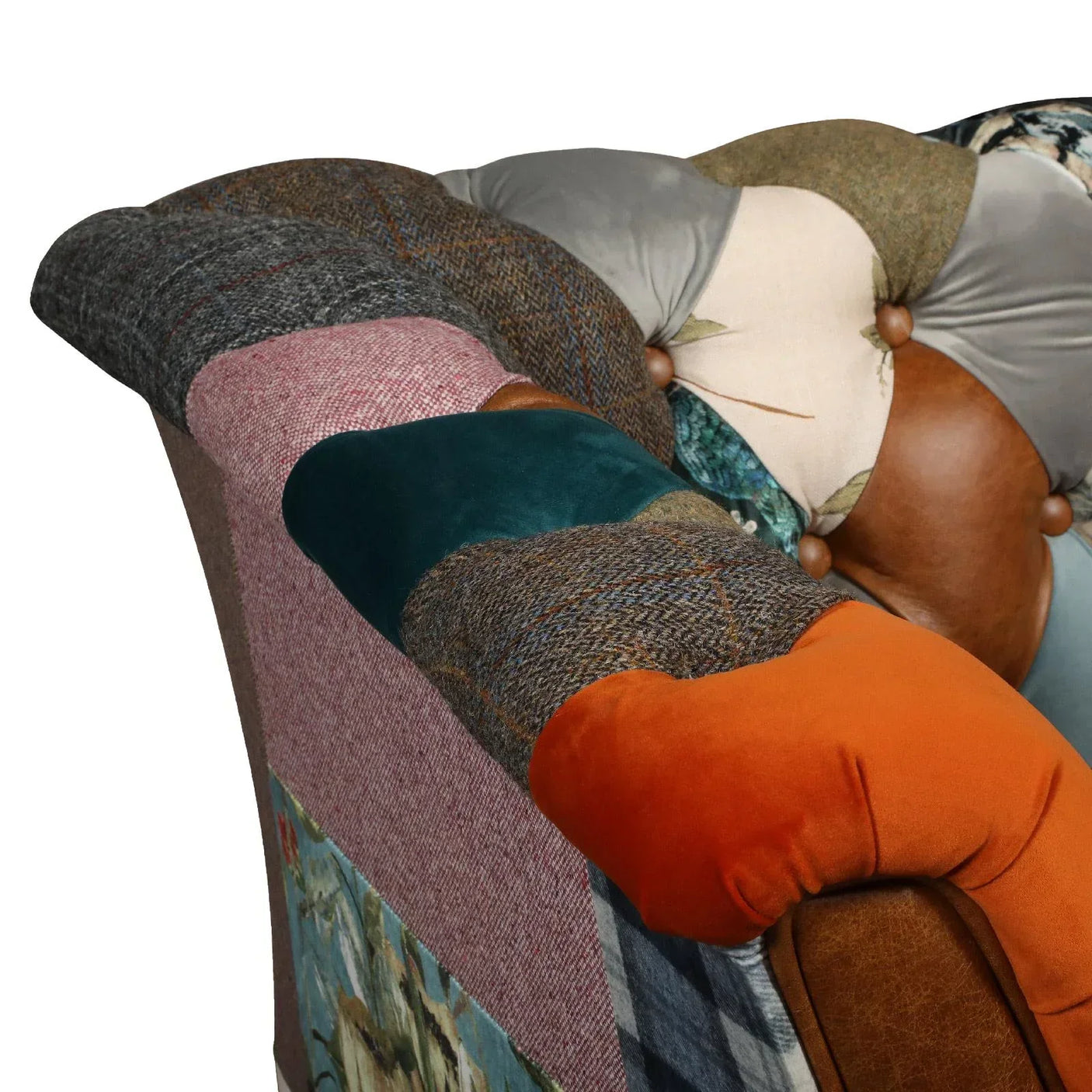 Patchwork fabric chesterfield sofa arm in mixed textures and colors, close-up view