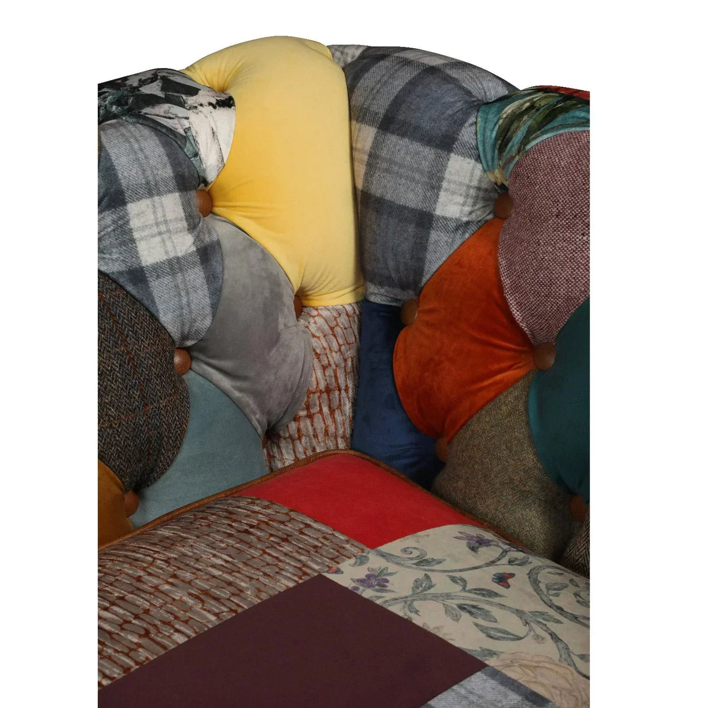 Patchwork fabric sofa close up with multicolor textures, velvet, tweed, and floral patterns