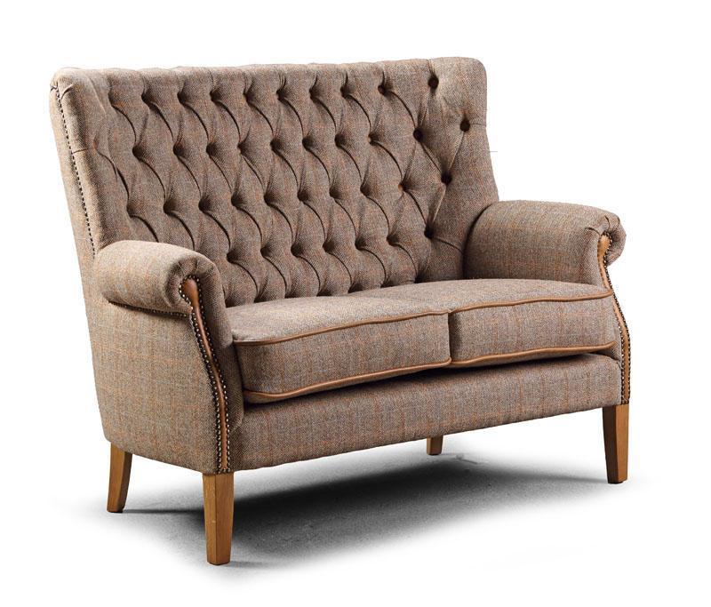 Brown fabric loveseat with button-tufted backrest, rolled arms and wooden legs