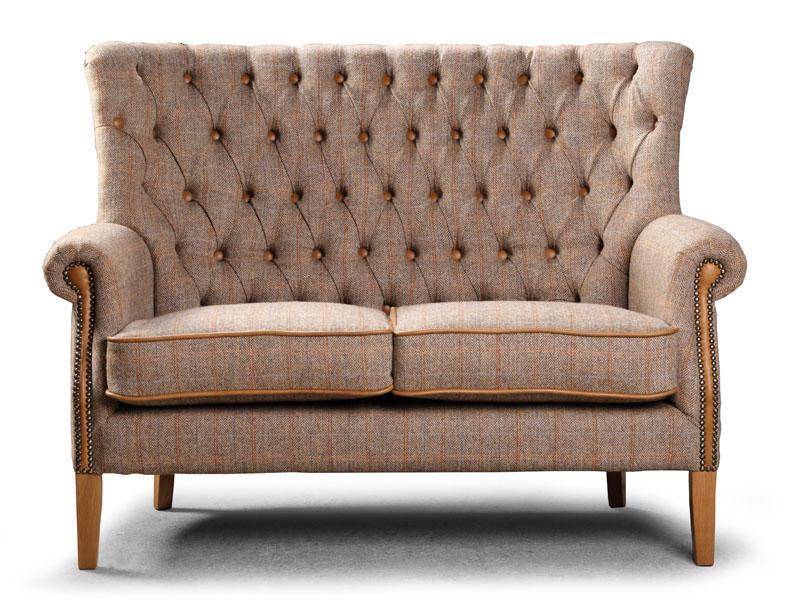 Brown fabric two seater sofa with button tufted back and wooden legs