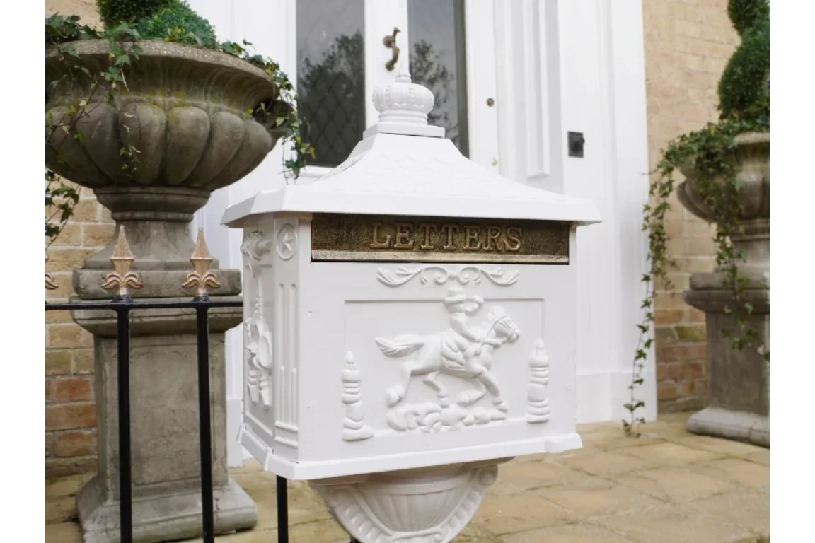 White cast iron post box with LETTERS sign and horse design at front door entrance