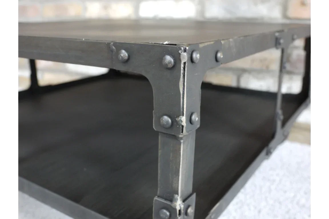 Industrial metal coffee table corner with rivet detail and black finish