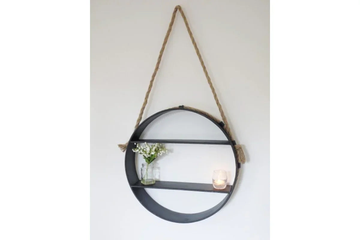 Round metal wall shelf with rope hanger, small glass vase and candle on display