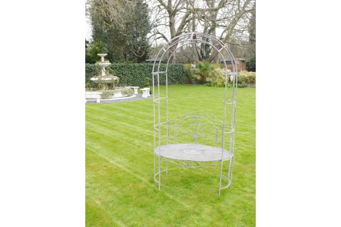 metal garden bench with arched trellis backrest on lawn, decorative outdoor seating