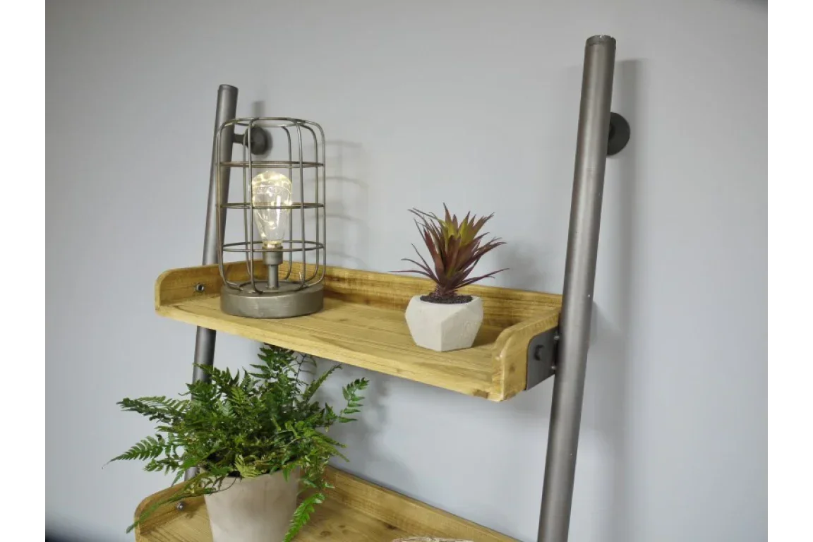 Industrial style wooden shelf with metal frame, table lamp, and small potted plant