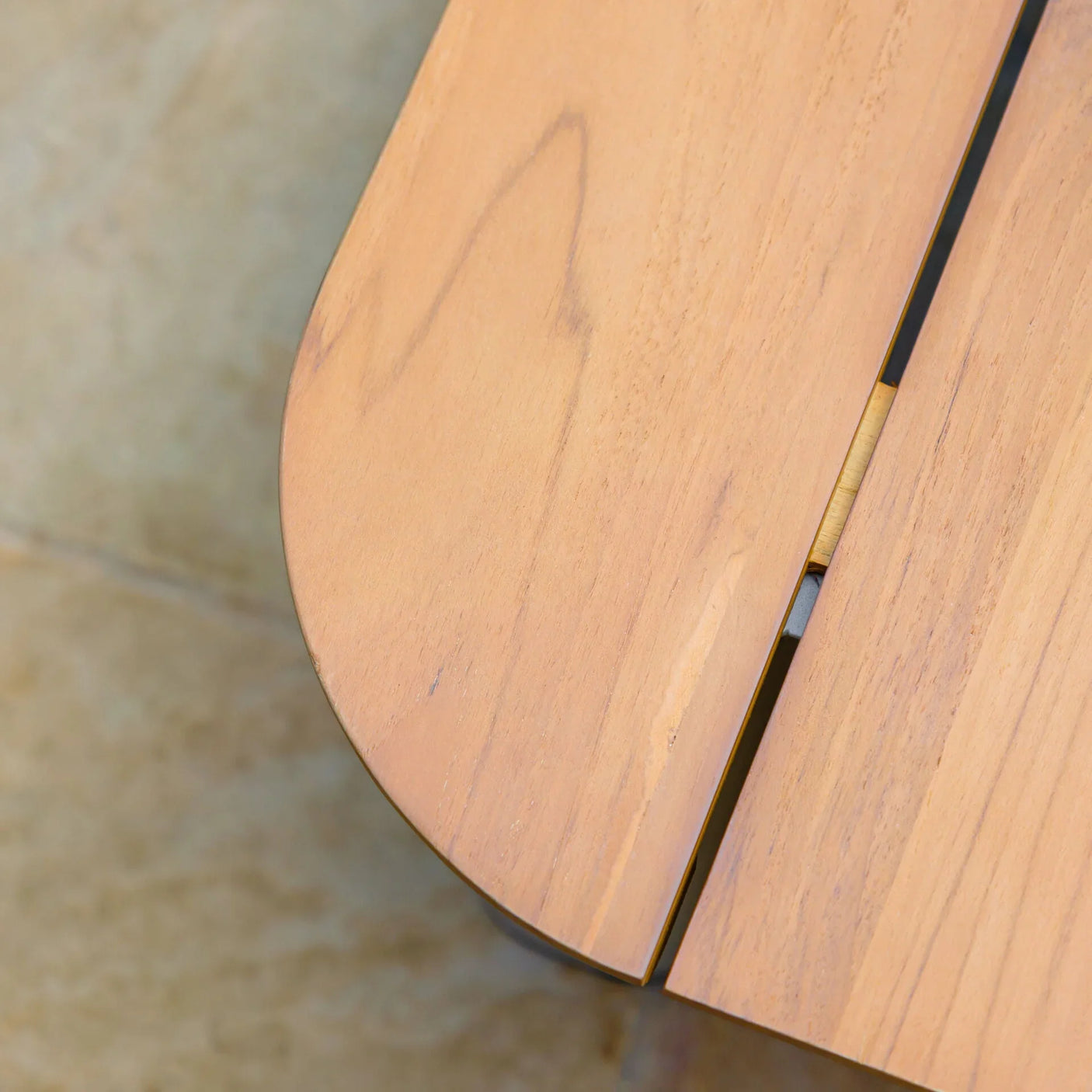 Closeup of wooden garden table corner with smooth finish and visible grain pattern