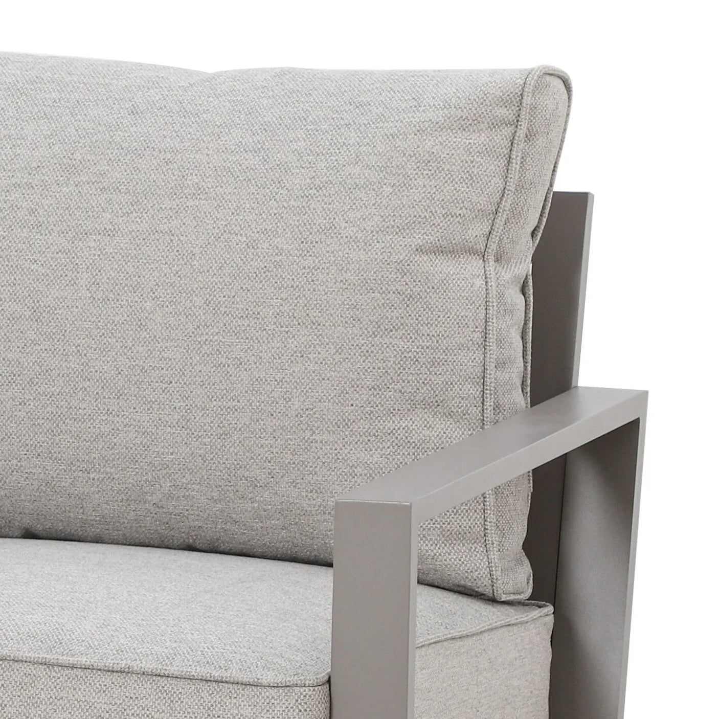 Close view of grey fabric armchair with metal armrest and plush back cushion