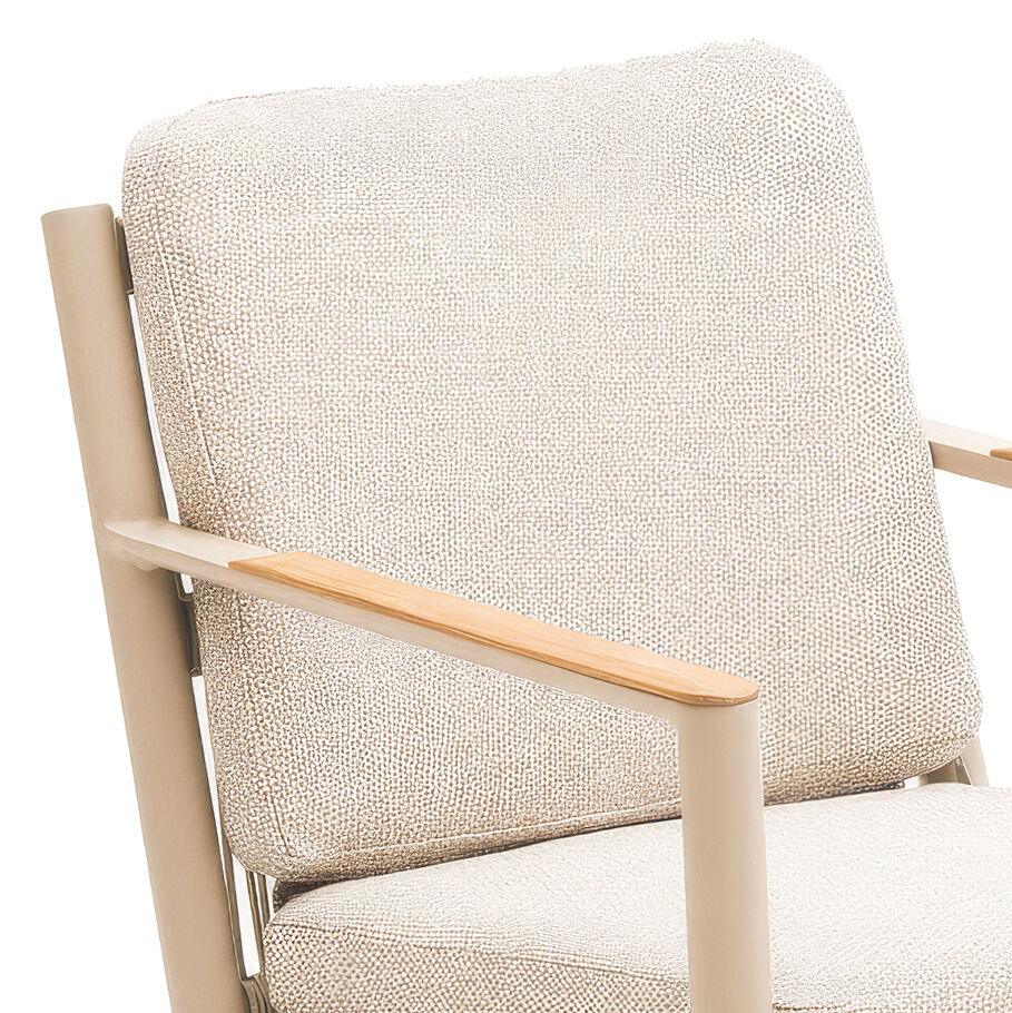 Beige fabric armchair with padded backrest and light wood armrest detail close-up