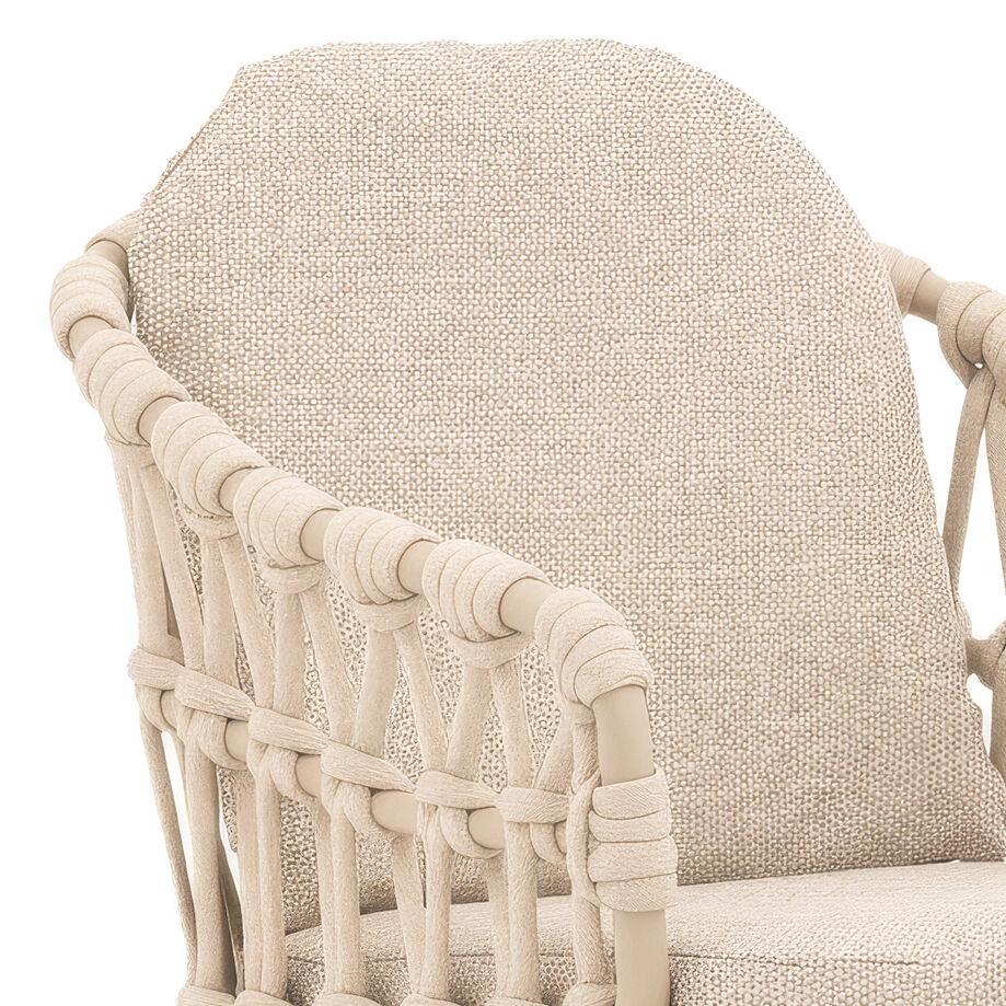 Beige woven rattan armchair with padded cushion and textured backrest, close-up view