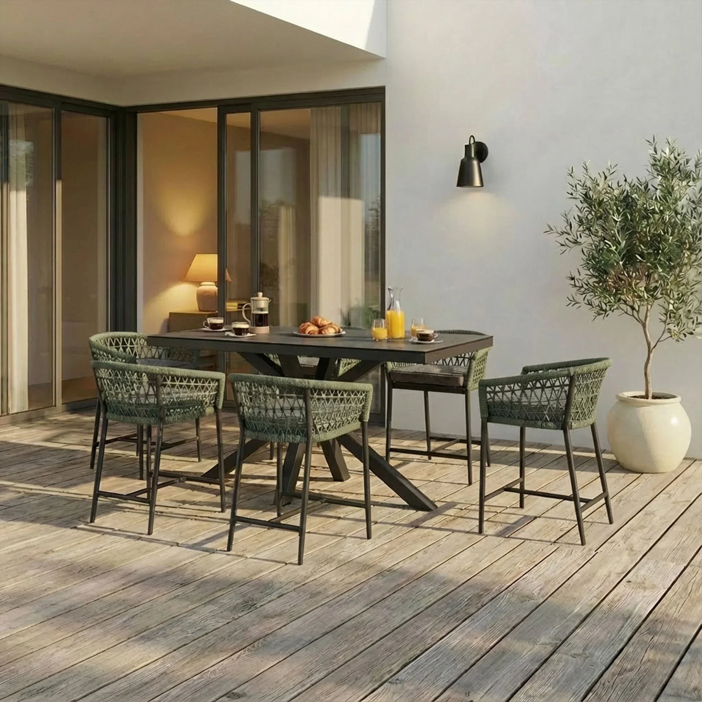 Outdoor dining set with woven green chairs and rectangular table on wooden patio