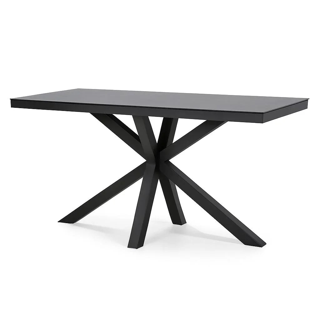 Rectangular black dining table with star-shaped metal legs, angled view