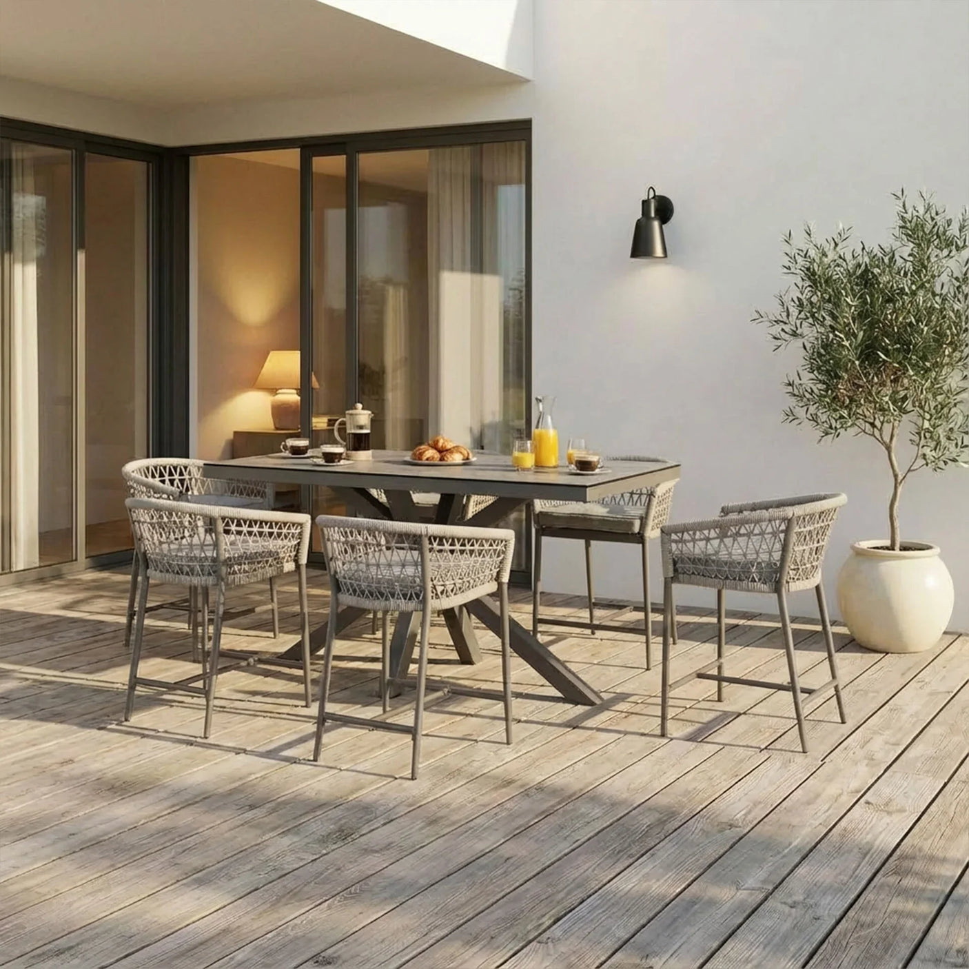 Grey outdoor dining set with six woven chairs and rectangular table on wooden patio