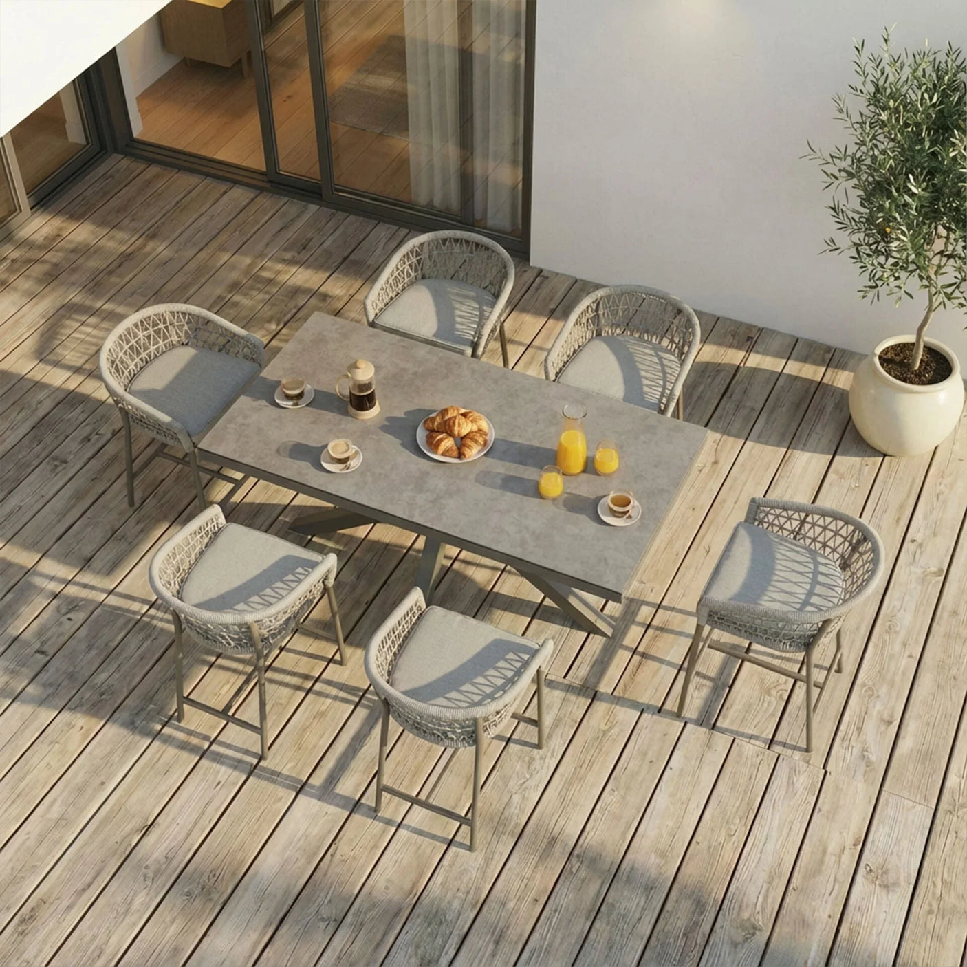 Grey outdoor dining set with six woven chairs and rectangular table on wooden patio