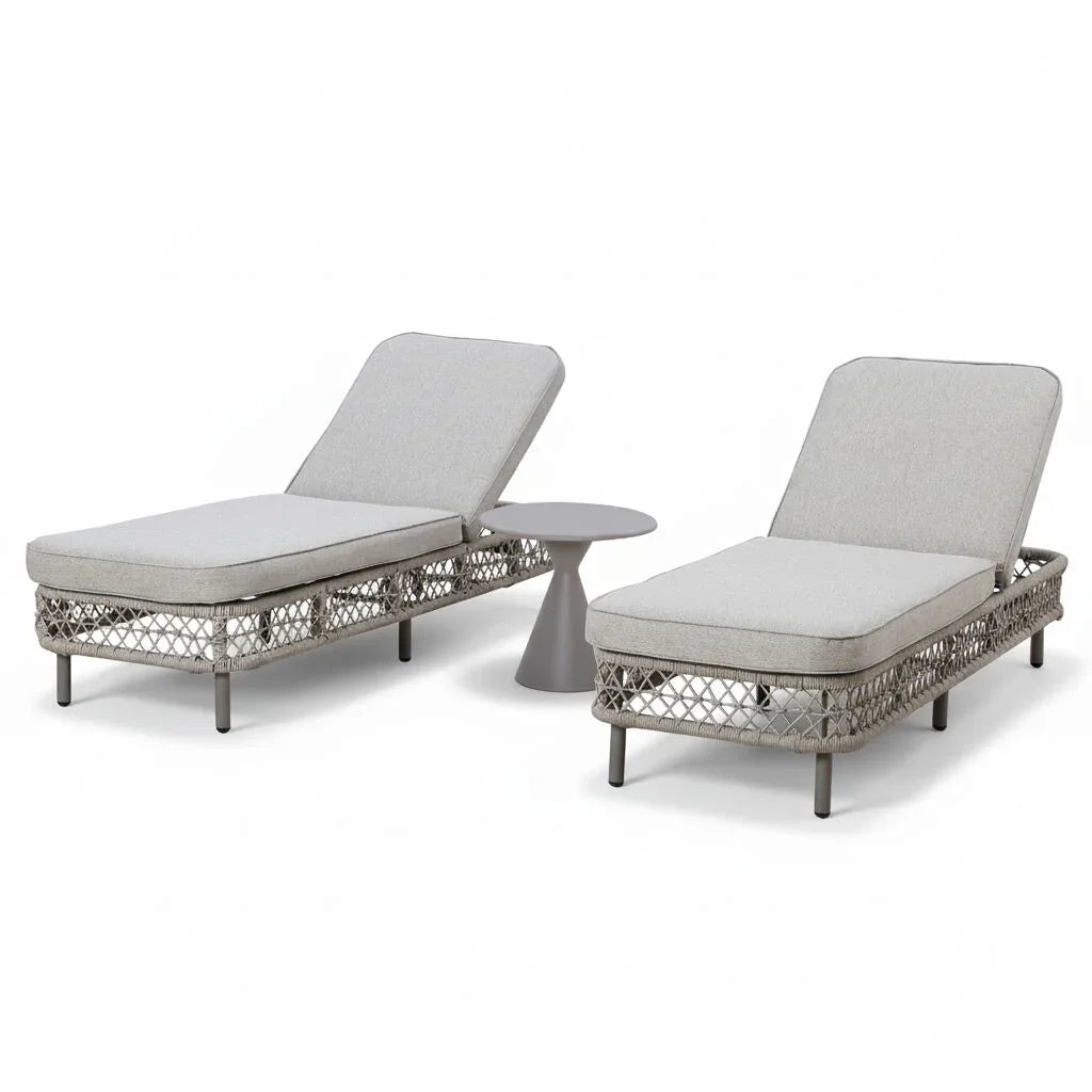 Grey rattan sun lounger set with side table, two cushioned loungers on white background
