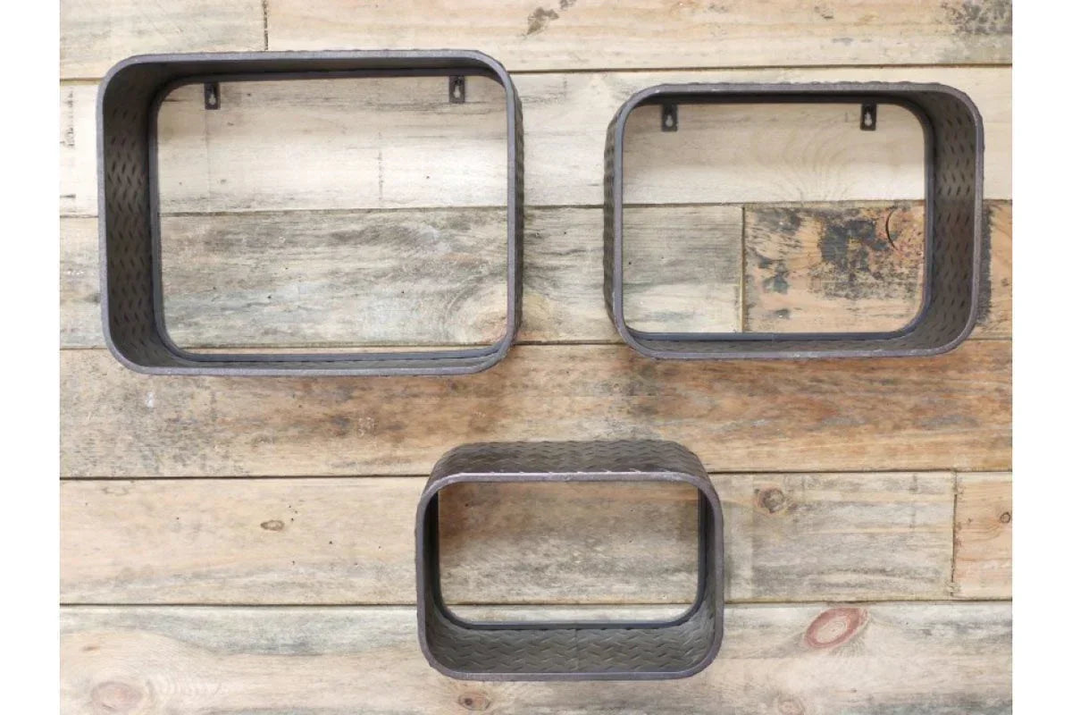 Set of three metal wall shelves with rounded corners mounted on wooden wall