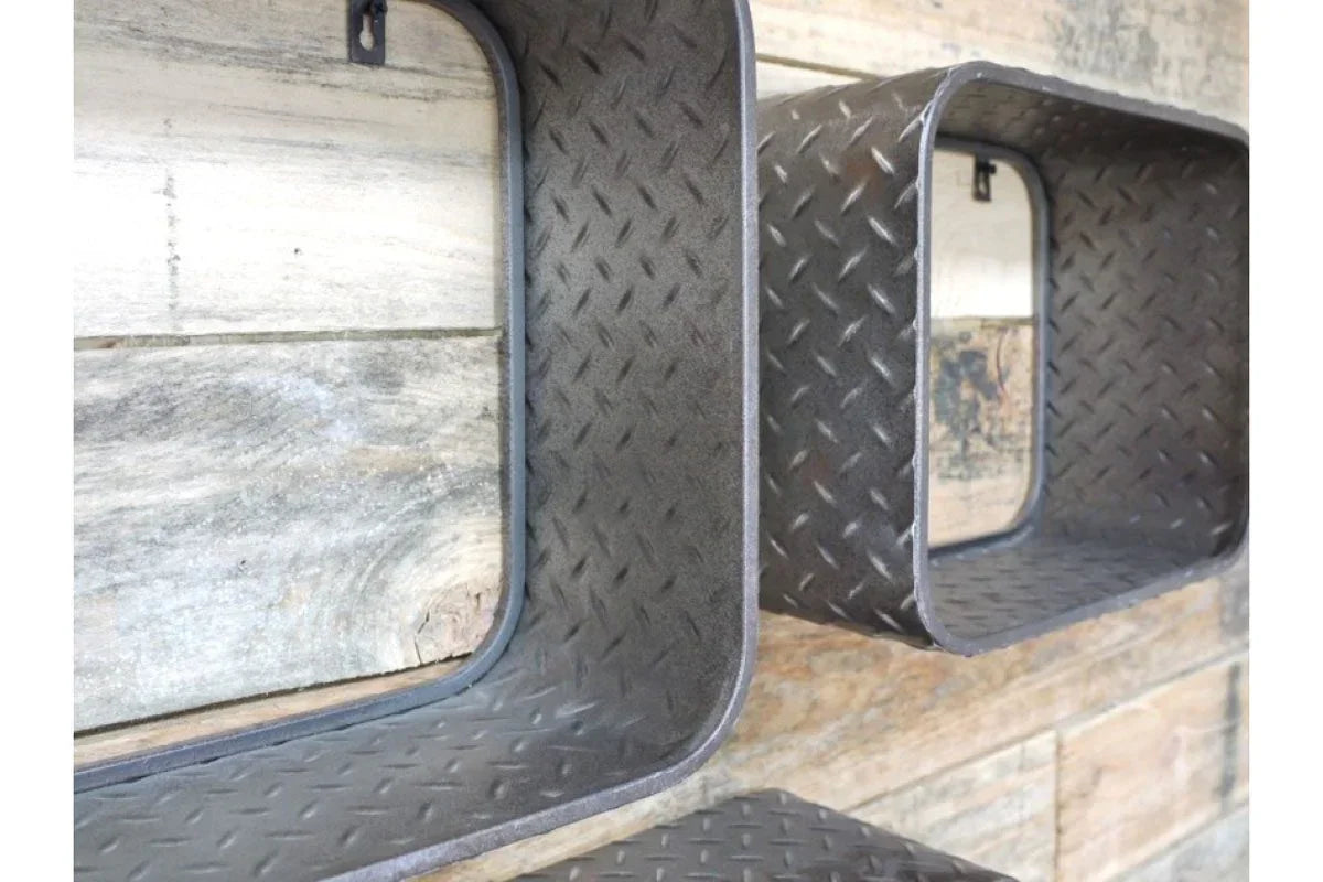 Industrial metal wall shelves with diamond plate texture on a wooden background