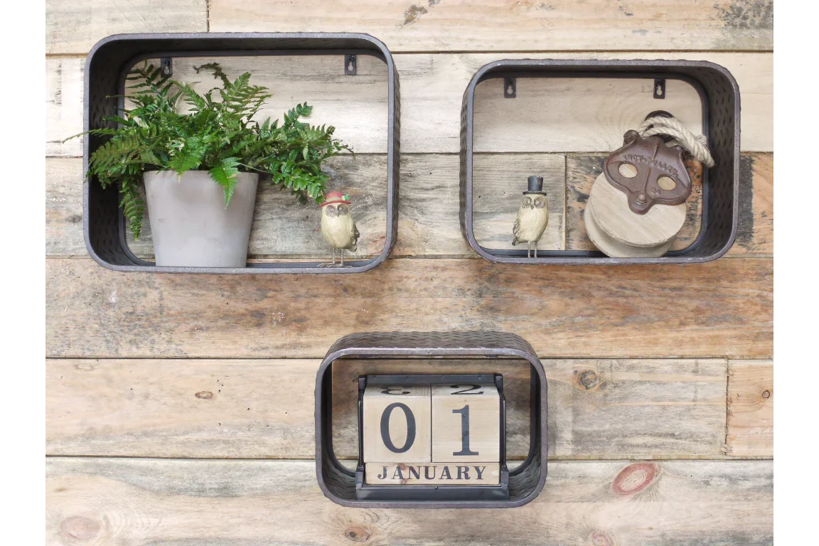 Wall mounted shelves with metal frame, potted plant, ornaments, and wooden block calendar