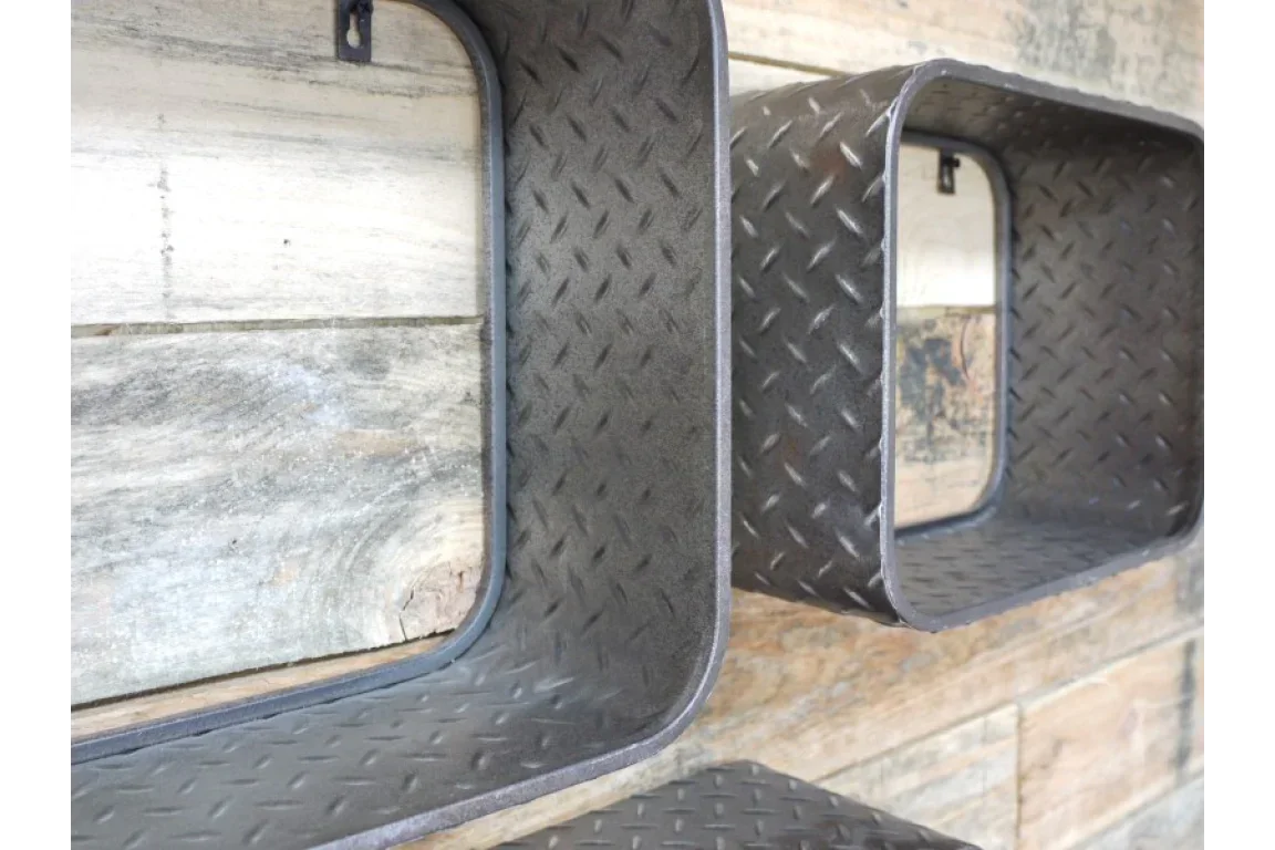 Industrial metal wall shelves with diamond plate pattern mounted on rustic wood background