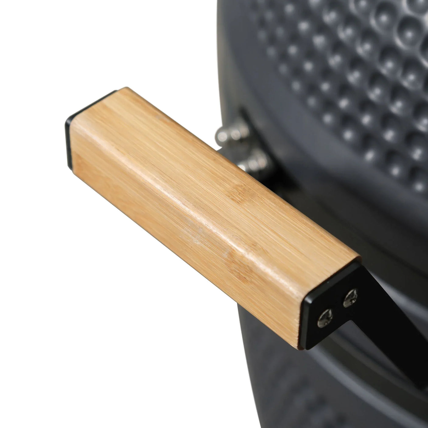 Closeup of bamboo handle attached to textured charcoal barbecue grill