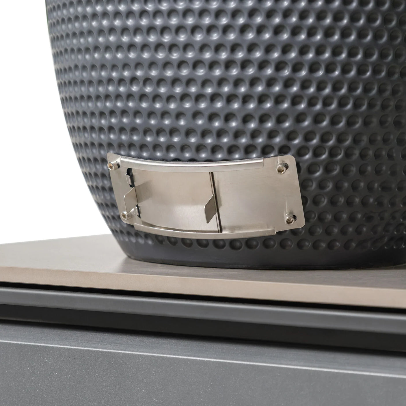Detail of grey textured ceramic fire pit with stainless steel vent on stone base