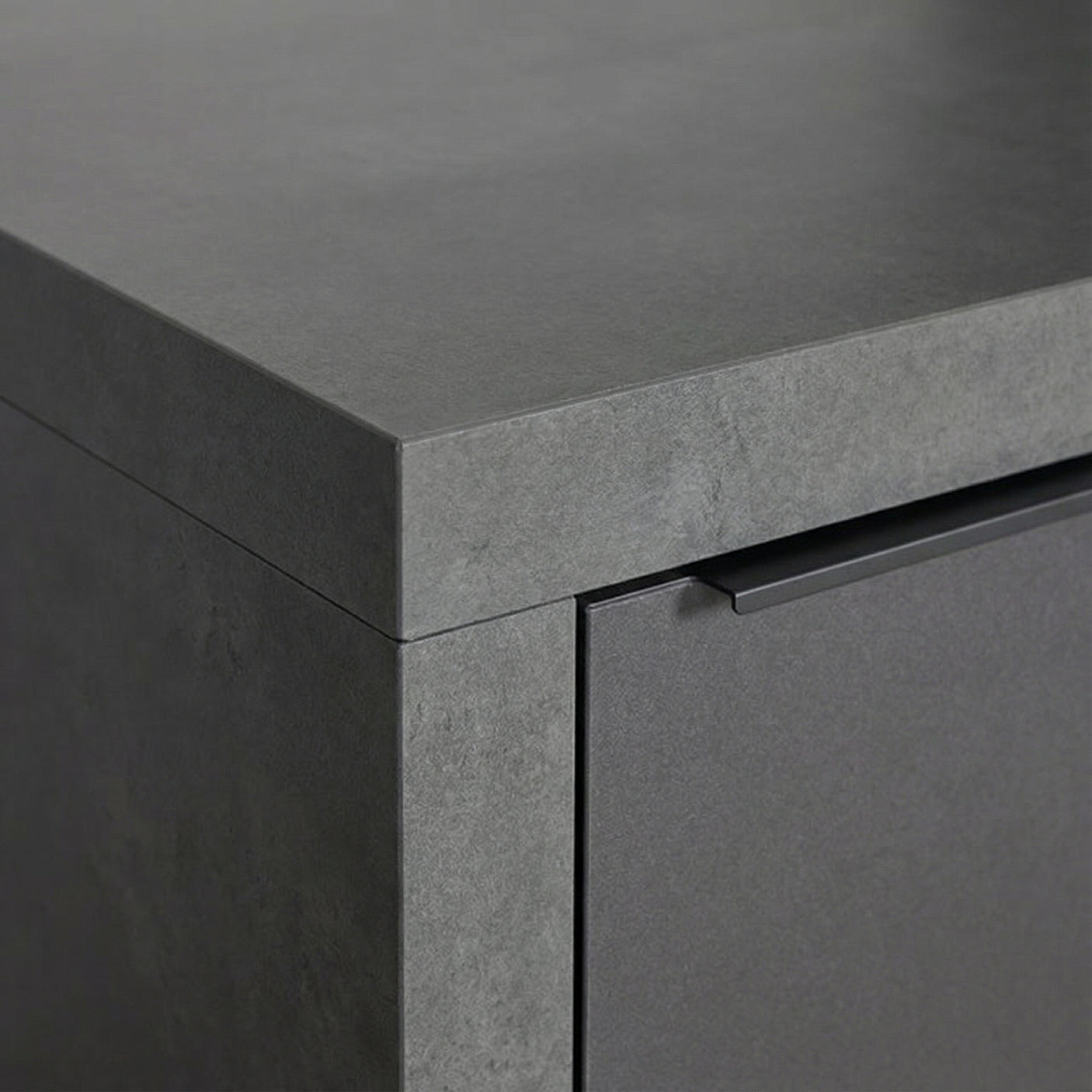 Close up of grey stone-effect cabinet with flat handle and modern finish