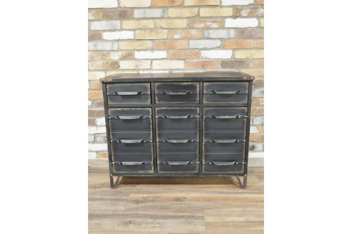 Industrial metal chest of drawers with nine compartments against brick wall