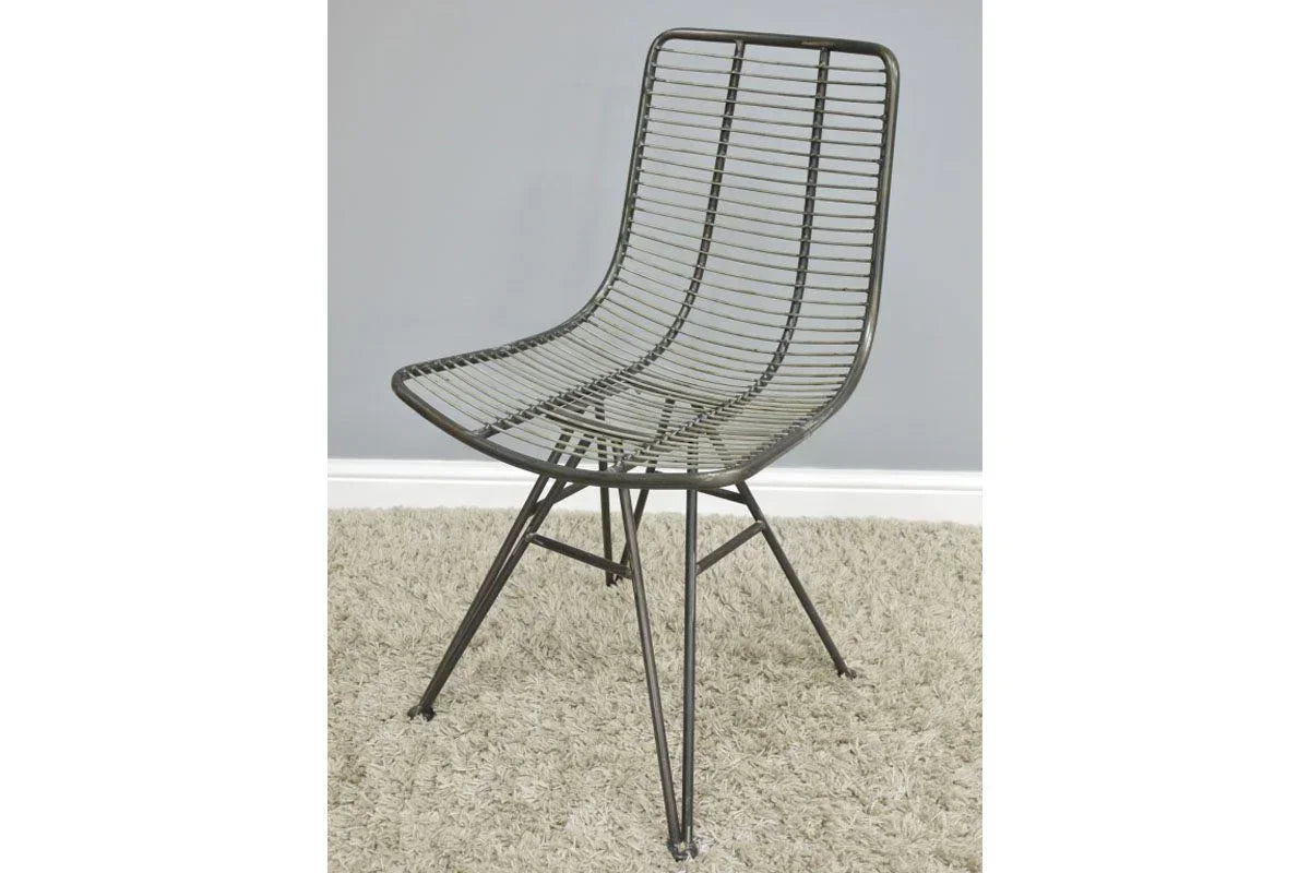 Black metal wire dining chair with angled legs on beige carpet