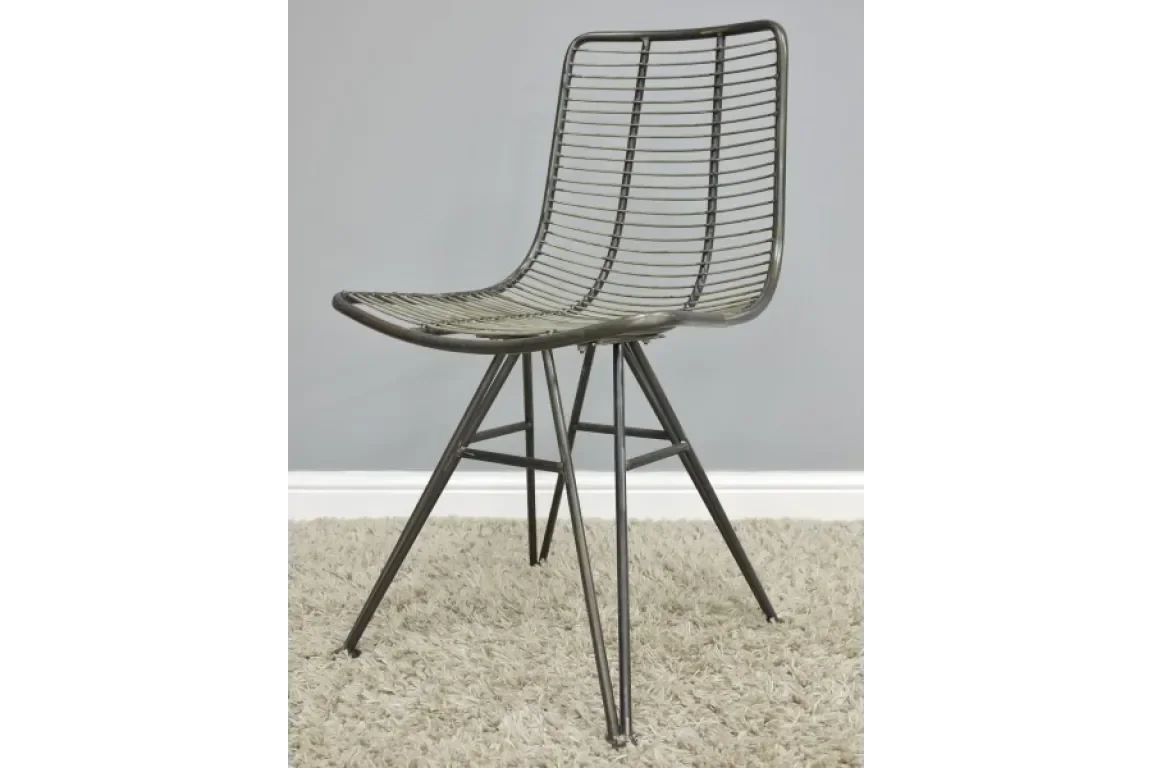 Black rattan dining chair with metal legs on beige carpet, side view