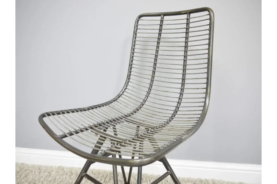 Metal wire dining chair with curved seat and backrest on carpeted floor