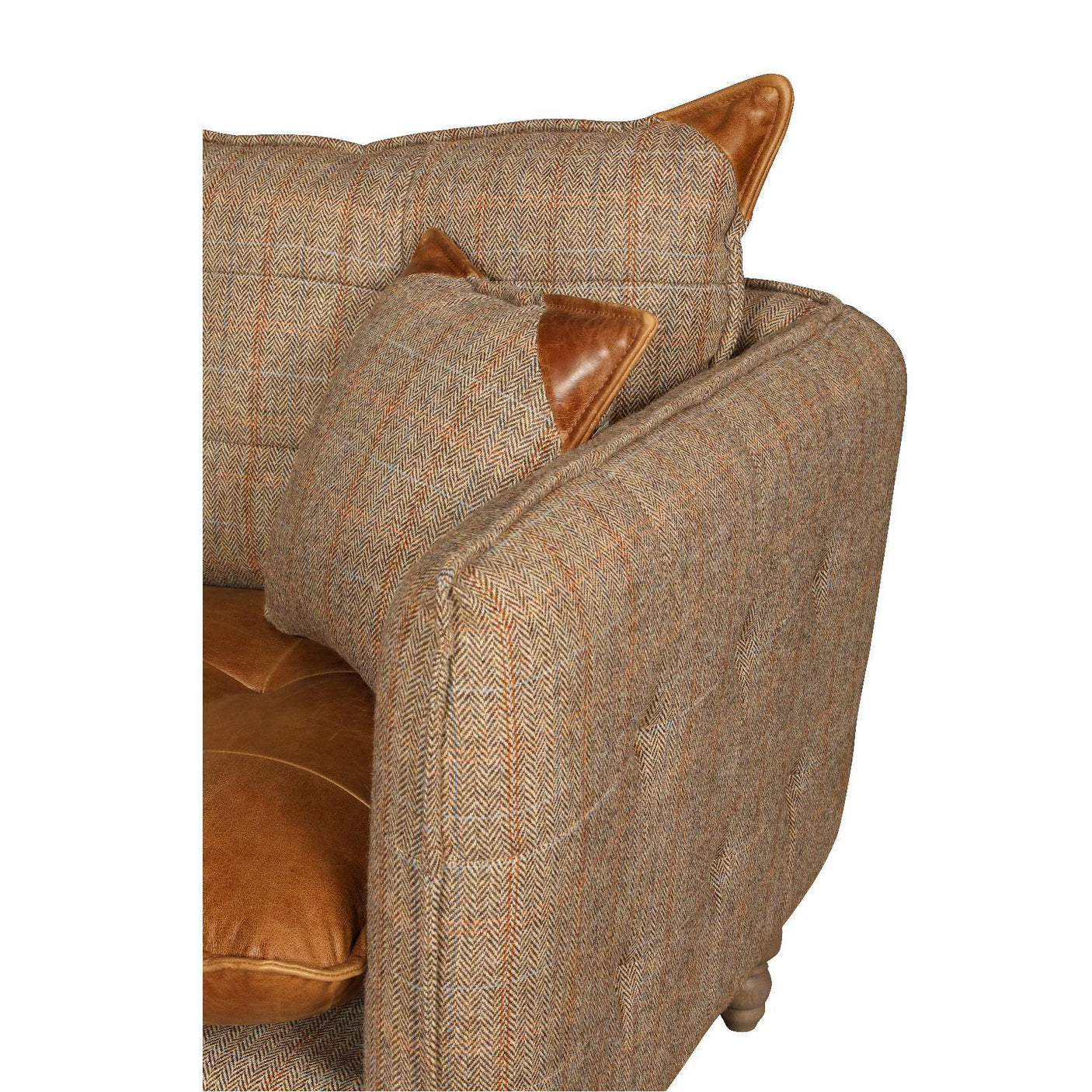 Herringbone armchair with tan leather cushions and accent pillows, close-up of side view