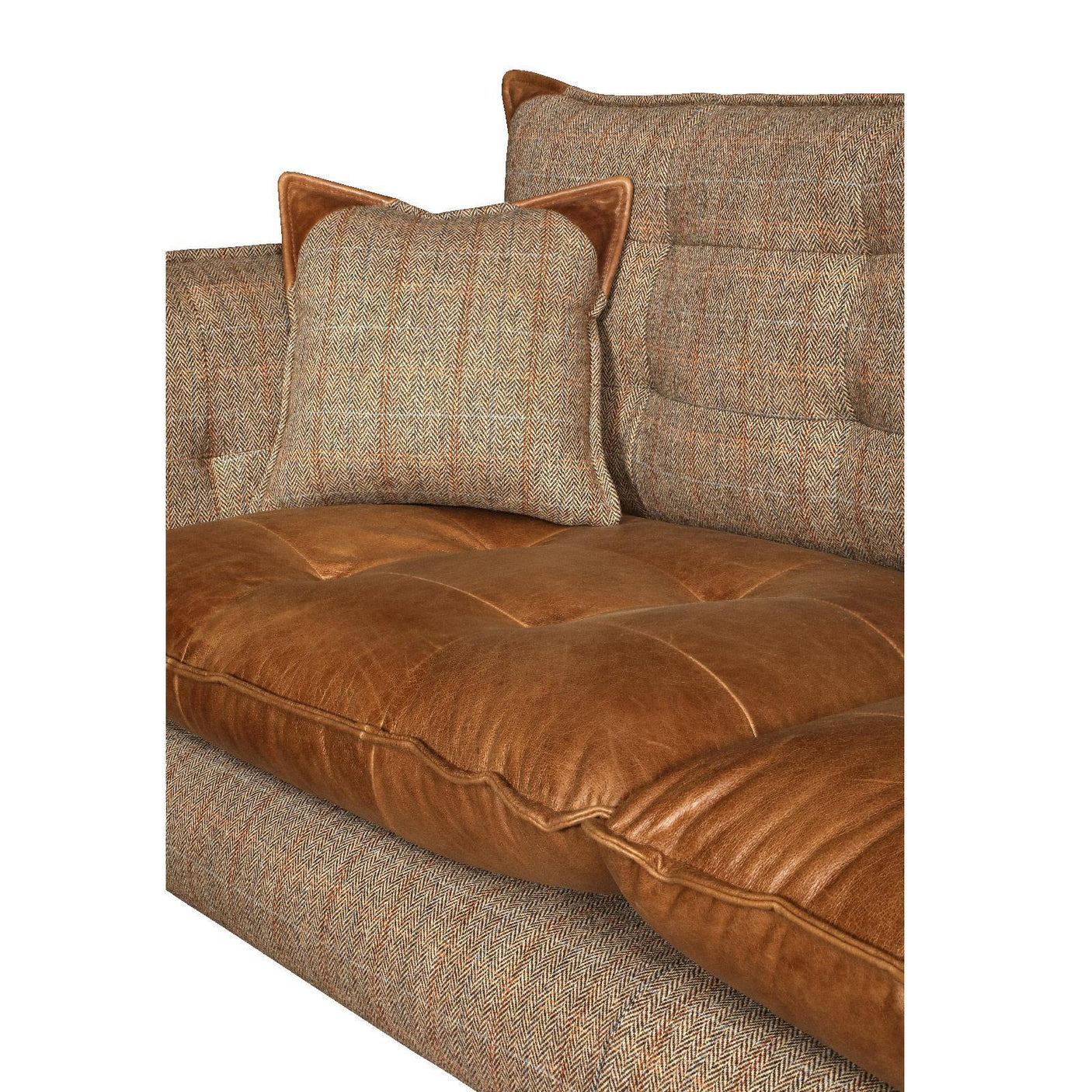 Brown leather and tweed fabric sofa closeup with matching cushion detail
