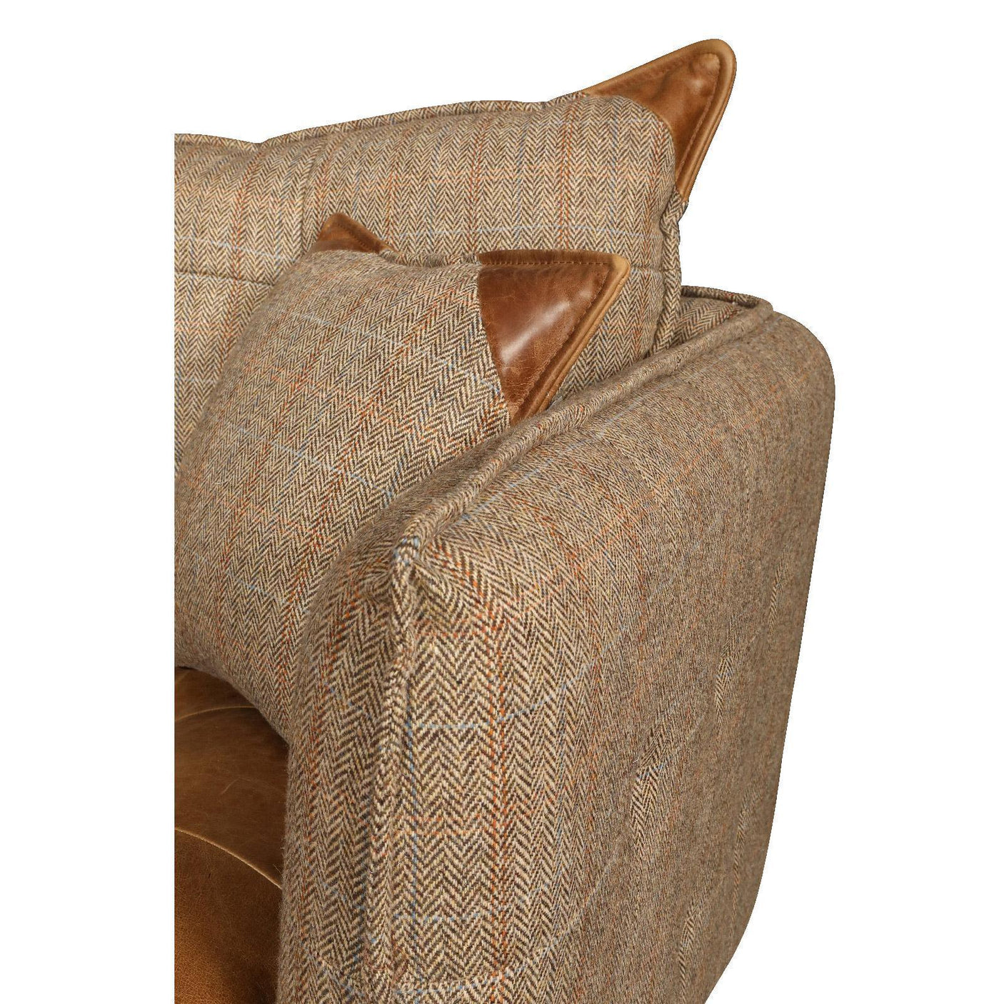 Brown herringbone sofa arm with leather trim cushions, close-up view of fabric texture
