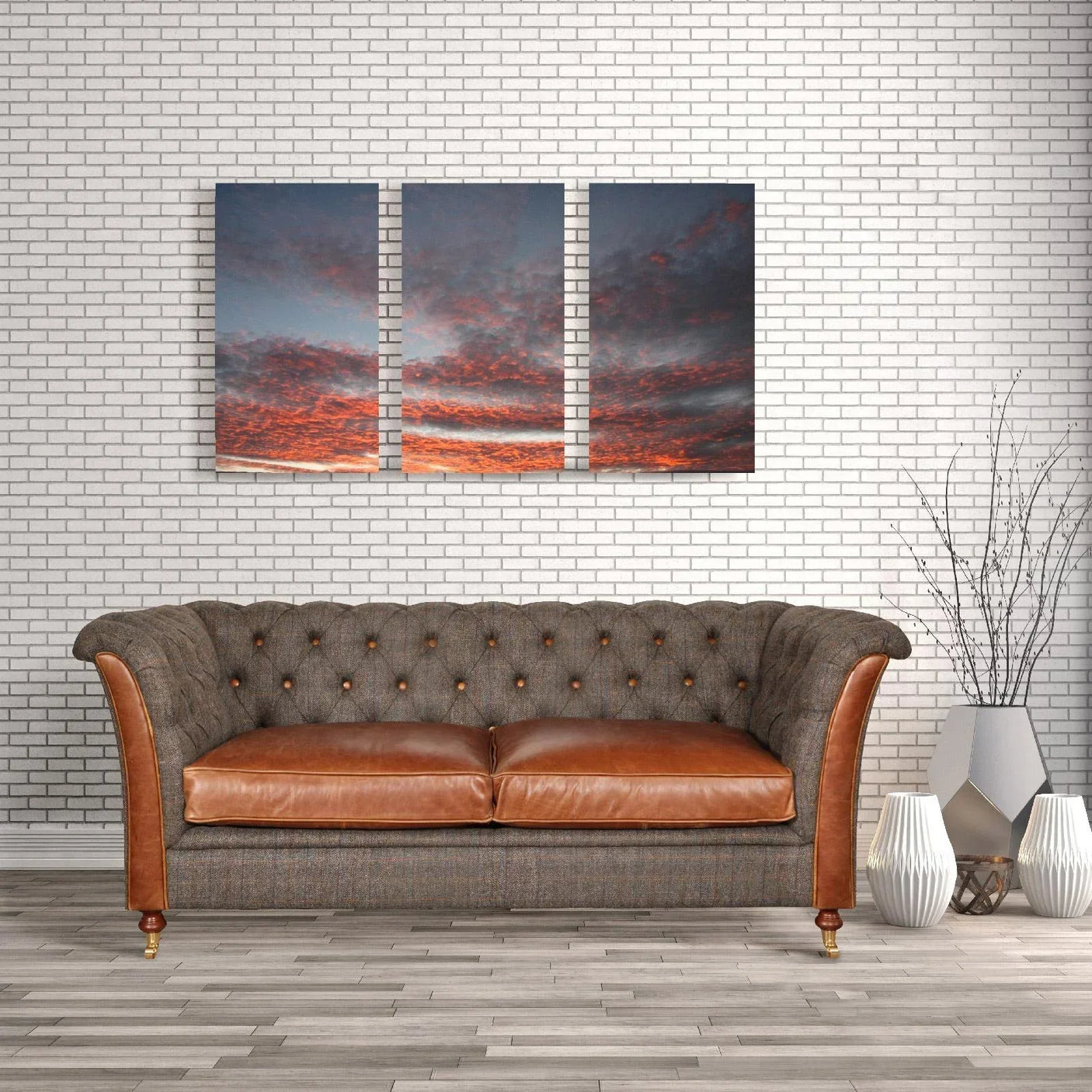 Brown leather and fabric sofa with button tufting in modern living room with wall art